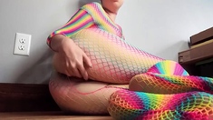 Teen in Rainbow Fishnets Fingers Herself