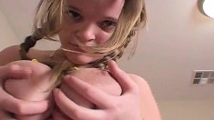 Blonde cutie with pigtails squeezes her juicy tits for the camera